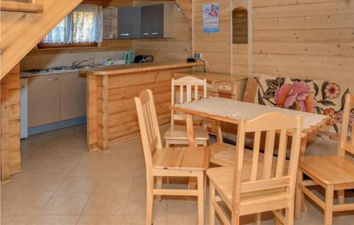 a kitchen and dining room with a table and chairs at 2 Bedroom Lovely Home In Sianozety in Sianozety