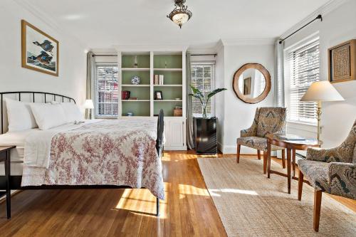 a bedroom with a bed and a table and chairs at The Monte Vista Hotel in Black Mountain