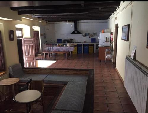 a kitchen and a living room with a table at Albergue San Javier - Solo para peregrinos in Astorga