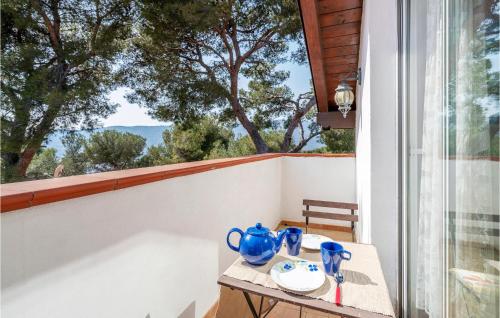 a table with blue vases on it on a balcony at Amazing Apartment In Andora in Marina dʼAndora