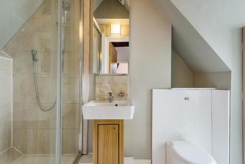 a bathroom with a sink and a shower at Sunny Loft in Center of London in London