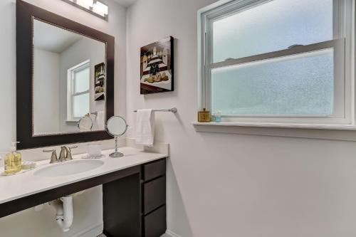 a bathroom with a sink and a mirror and a window at Private Pool - ADA - Pet Friendly - Fenced Yard - 884 Oak Lane in Fernandina Beach