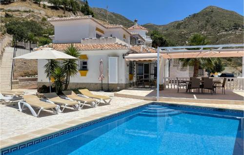 a villa with a swimming pool and a house at Casa Anttonio in Cómpeta