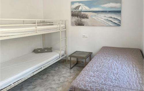 a small bedroom with two bunk beds and a table at Casa Anttonio in Cómpeta