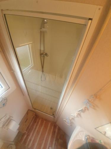 a bathroom with a mirror and a shower at Fantasy Island and Beach 6 Berth 545 in Ingoldmells