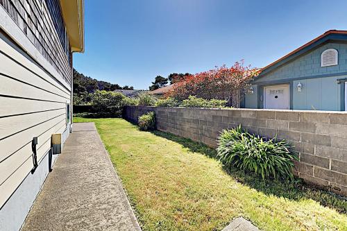 a brick retaining wall next to a house at Blue Waves Overlook in Newport