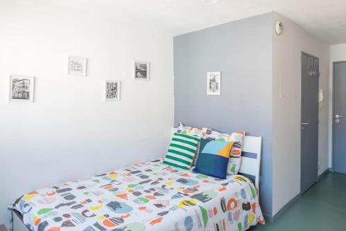 a bedroom with a bed with a colorful comforter at Part-Dieu Lyon Appart in Lyon