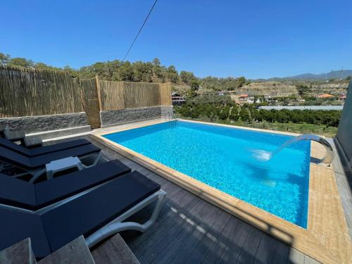 a swimming pool on the deck of a house at Villa Defne in Fethiye