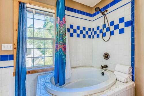 uma casa de banho azul e branca com uma banheira e uma janela em Second Chair Inn em Rhododendron