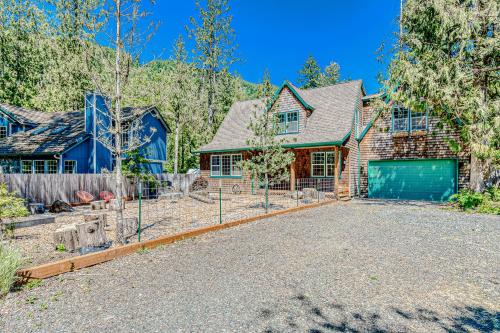 a house with a fence in front of a driveway at Second Chair Inn in Rhododendron