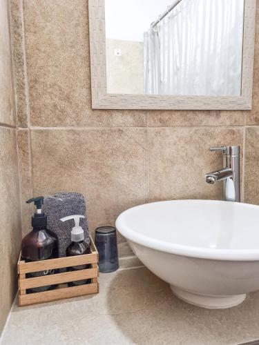 a bathroom with a white sink and a mirror at H. Galaxia in Oaxaca City