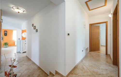 a hallway with white walls and tile floors at Nice Home In Vinez With 3 Bedrooms, Wifi And Outdoor Swimming Pool in Vinež