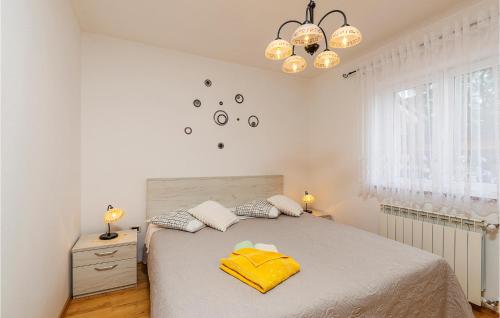 a bedroom with a bed with a yellow towel on it at Nice Home In Vinez With 3 Bedrooms, Wifi And Outdoor Swimming Pool in Vinež