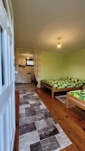 a room with two beds in a room at Apartman Panorama in Mokra Gora