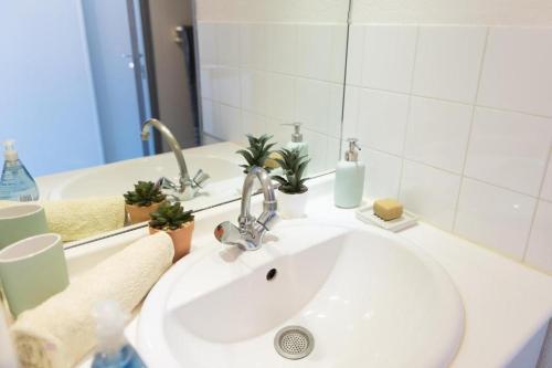 une salle de bain avec un lavabo blanc et un miroir dans l'établissement studio part dieu, à Lyon