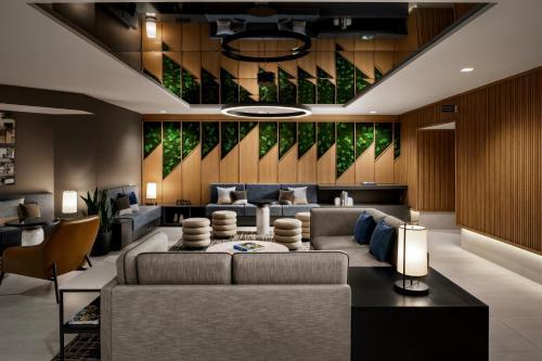 a living room with a couch and chairs at Hyatt Place Montreal - Downtown in Montréal