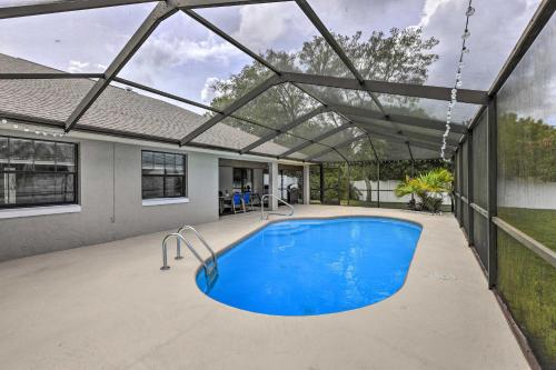 a swimming pool in a house with awning at Ocala Escape with Private Pool, Pets Welcome! in Marion Oaks