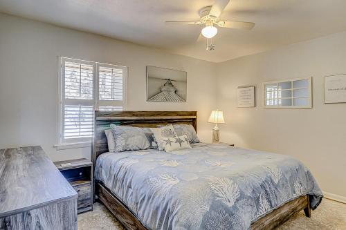 a bedroom with a bed and a ceiling fan at Dunes Villas in Hilton Head Island