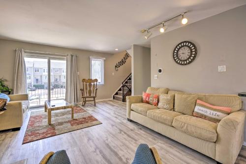a living room with a couch and a table at Brigantine Retreat with Balconies - Walk to Beach! in Brigantine