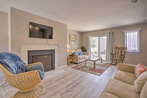 a living room with a couch and a fireplace at Brigantine Retreat with Balconies - Walk to Beach! in Brigantine