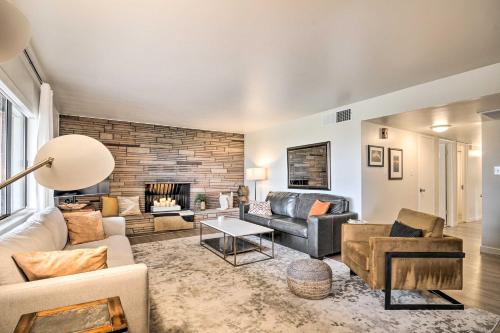 a living room with a couch and a fireplace at Lake Powell Views Mid-Century Home in Page in Page