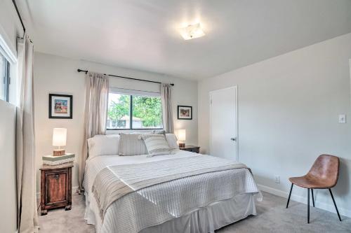 a bedroom with a bed and a window and a chair at Lake Powell Views Mid-Century Home in Page in Page