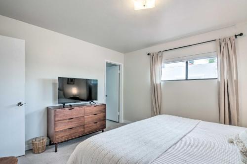 a bedroom with a bed and a flat screen tv at Lake Powell Views Mid-Century Home in Page in Page