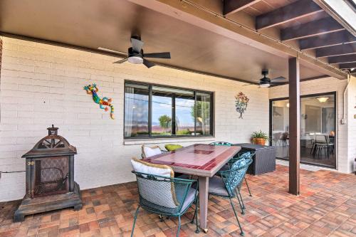 a patio with a table and chairs and a fireplace at Lake Powell Views Mid-Century Home in Page in Page