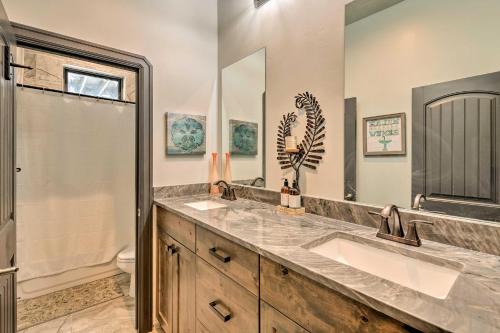 a bathroom with two sinks and a shower at Spacious Tooele Unit with Sprawling Mtn Views! in Tooele