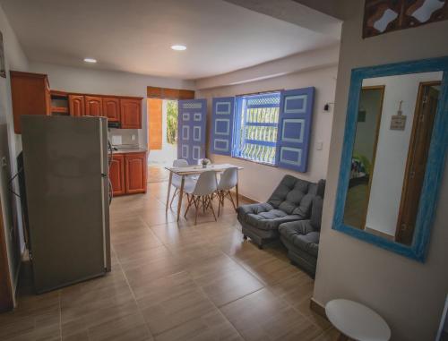 a kitchen and a living room with a couch and a table at Apartahotel Villa carolina 1 in Jericó