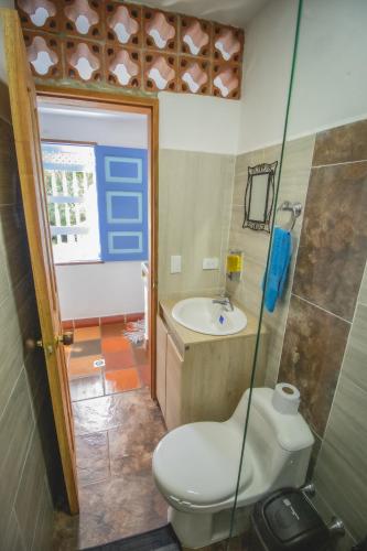 a bathroom with a toilet and a sink at Apartahotel Villa carolina 1 in Jericó