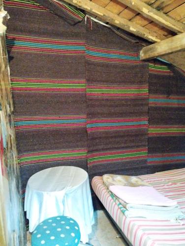 a room with a couch and a table and a chair at Хижа Ловна в Рила in Panichishte