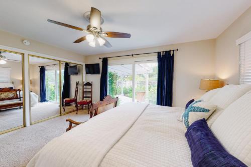 a bedroom with a bed and a ceiling fan at East Valley Manor in Montecito