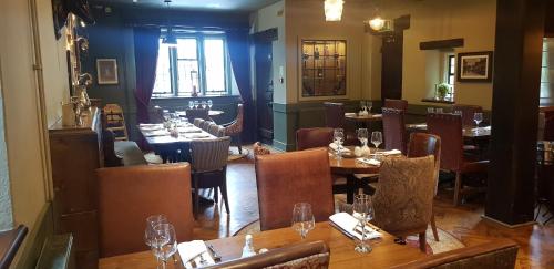 a dining room with a wooden table and chairs at Kings Arms in Bradford on Avon