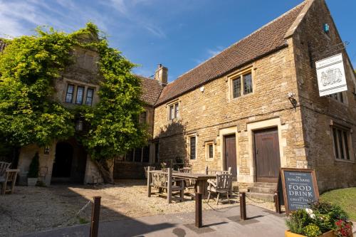 an old building with a picnic table in front of it at Kings Arms in Bradford on Avon