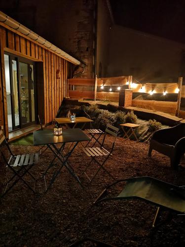 a living room with a couch and tables and lights at Gîte de charme : A la volette in Plombières-les-Bains