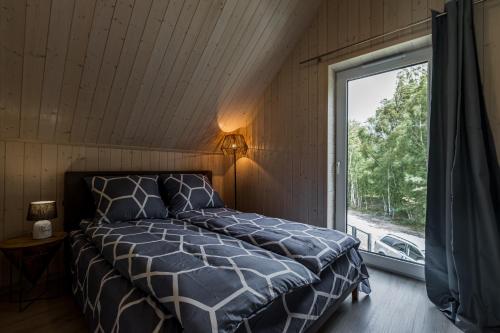 Postel nebo postele na pokoji v ubytování BALTIKI domki całoroczne nad morzem