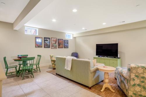 a living room with a couch and a tv and a table at The Ship's Bridge in Annapolis