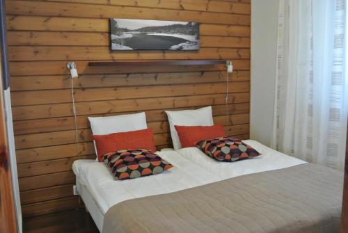 ユッラスヤルヴィにあるVilla Ylläs 101の木製の壁のベッドルームにツインベッド2台が備わります。