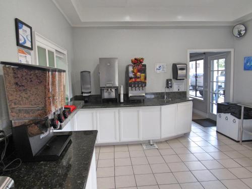 a large kitchen with a counter with aperature at Capri Suites Anaheim in Anaheim