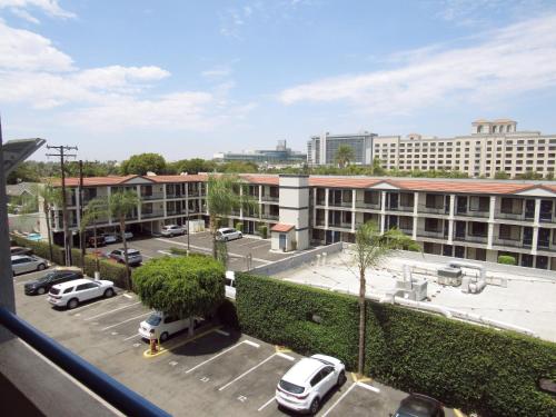 a view of a parking lot with cars parked at Capri Suites Anaheim in Anaheim