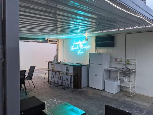 a kitchen with a refrigerator and a table and chairs at Investigator Beach Breeze Apartments U3 in Kingscote