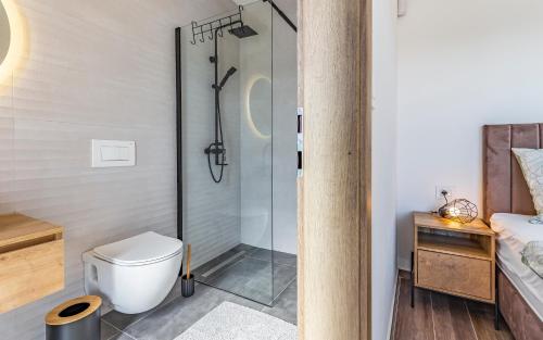 a bathroom with a shower and a toilet at Villa RougeMarin - Marin with private pool in Medulin