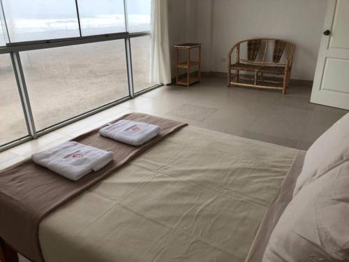uma cama com duas toalhas num quarto em Casa de Playa VISTAMAR con Piscina, Camaná - Arequipa em Los Cerrillos