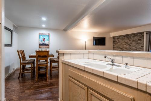 a kitchen with a sink and a dining room at Warm and cozy upgraded 2 bedrm 2 bath single level condo in Snowcreek complex phase IV 563 Sleeps 6 in Mammoth Lakes