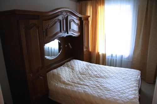 a bedroom with a bed with a wooden frame at Cosy Apartments on Kievskaya in Moscow