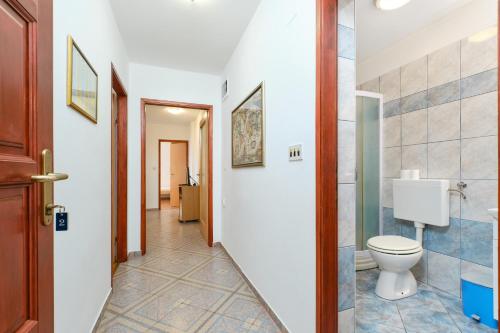 a bathroom with a toilet and a hallway at Apartments with a parking space Cunski, Losinj - 7867 in Čunski