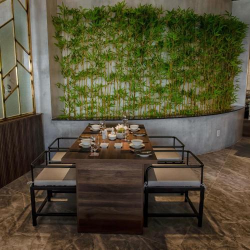 a dining room with a table and two chairs at Ohana Village in Phương Phi