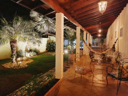 a porch with chairs and a hammock on it at Spa Belo Quinto Prime in Brotas