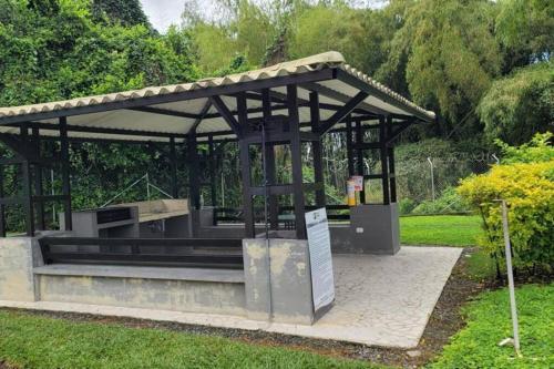 a bus stop with a bench in a park at APARTAMENTO en el QUINDIO in La Tebaida
